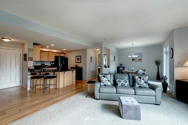 a living room with furniture and kitchen view