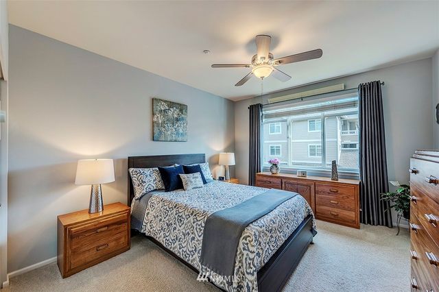 a bedroom with a large bed and a chandelier