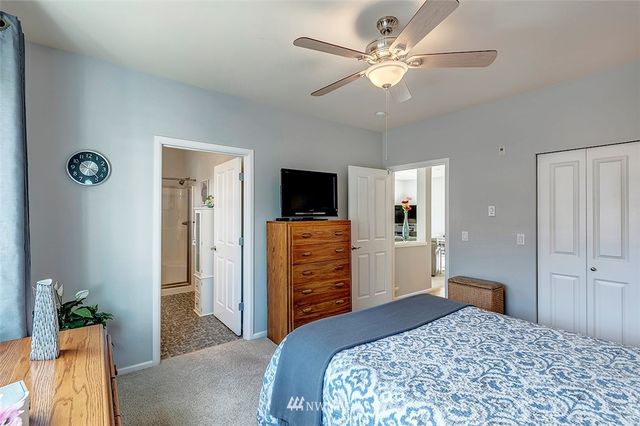 a bedroom with a bed and a television