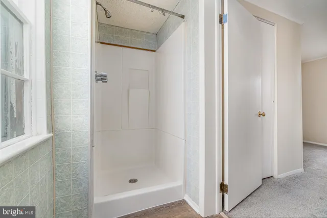 a bathroom with a glass shower door