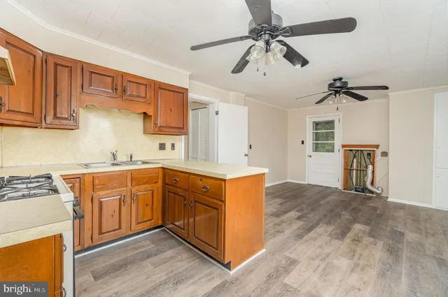 a kitchen with stainless steel appliances granite countertop a stove a sink dishwasher and a refrigerator