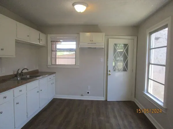 a kitchen with a sink cabinets and window