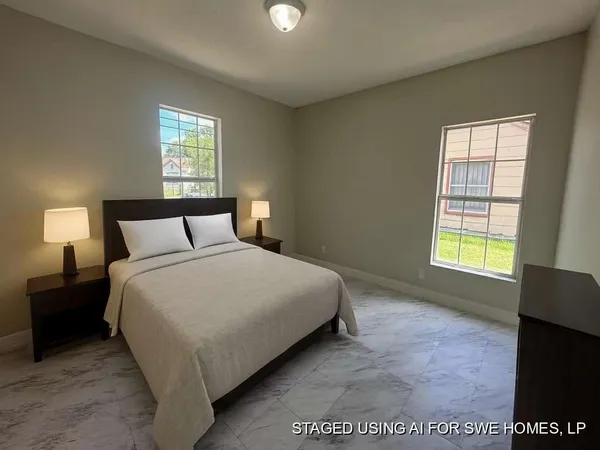 a bedroom with a bed and a window
