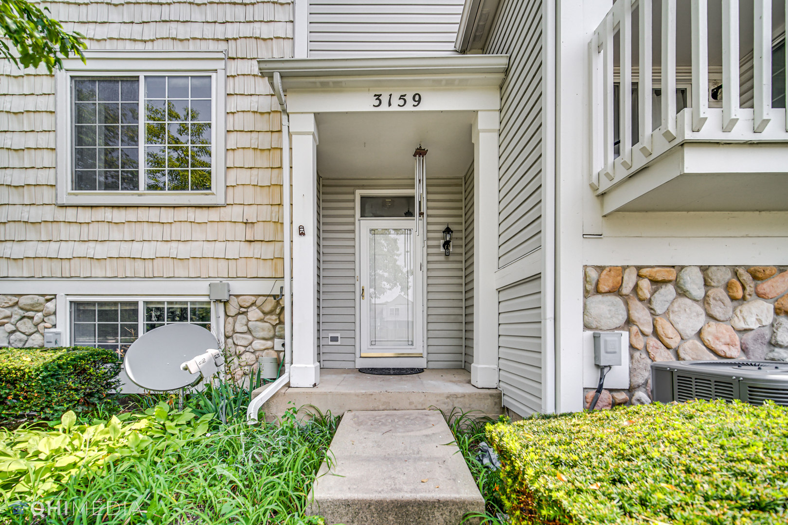 3159 Teal Bay Court Aurora, IL 60503 - Photo 3 of 22 a front view of a house with a garden