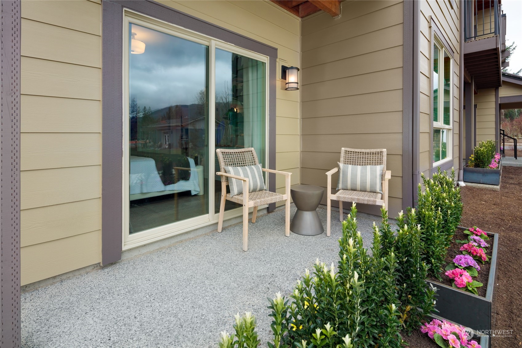 1237 Meander Way Southeast, Unit 101 North Bend, WA 98045 - Photo 12 of 13 a view of a porch with chairs and potted plants