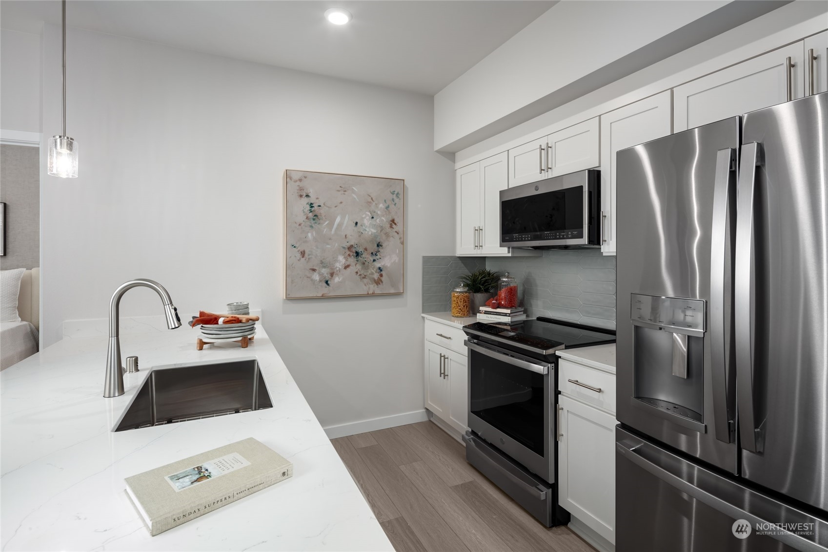1237 Meander Way Southeast, Unit 101 North Bend, WA 98045 - Photo 4 of 13 a kitchen with stainless steel appliances a refrigerator stove and microwave