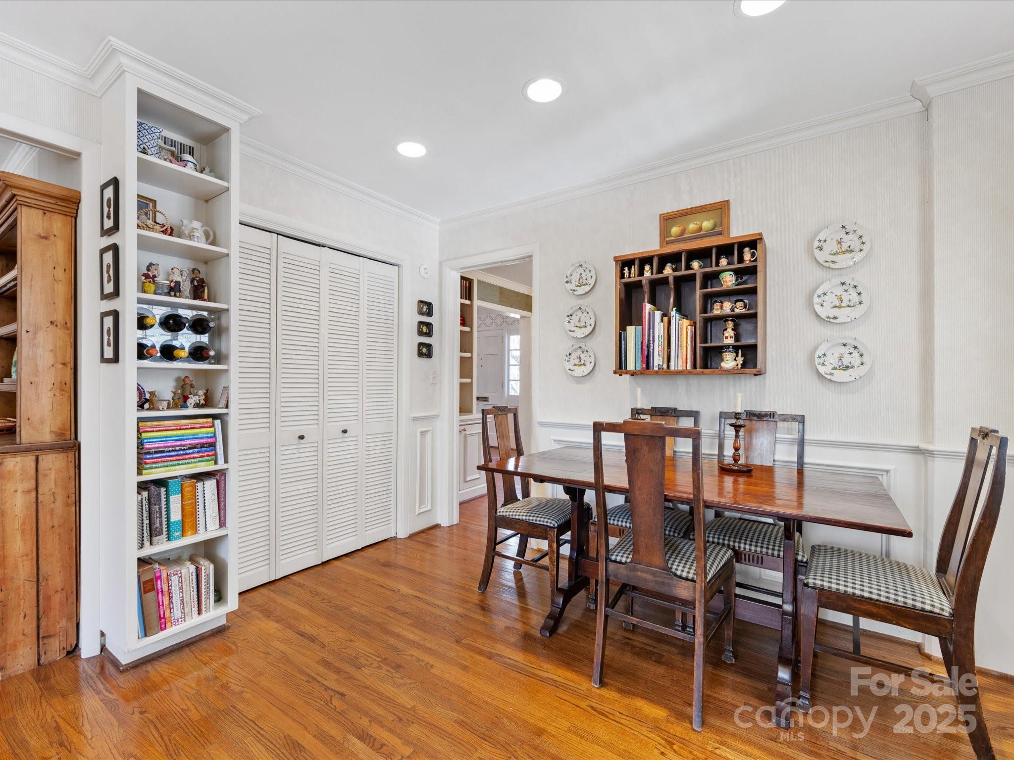555 Manning Drive, Unit 7 Charlotte, NC 28209 - Photo 11 of 45 a view of a livingroom with furniture and bookshelf