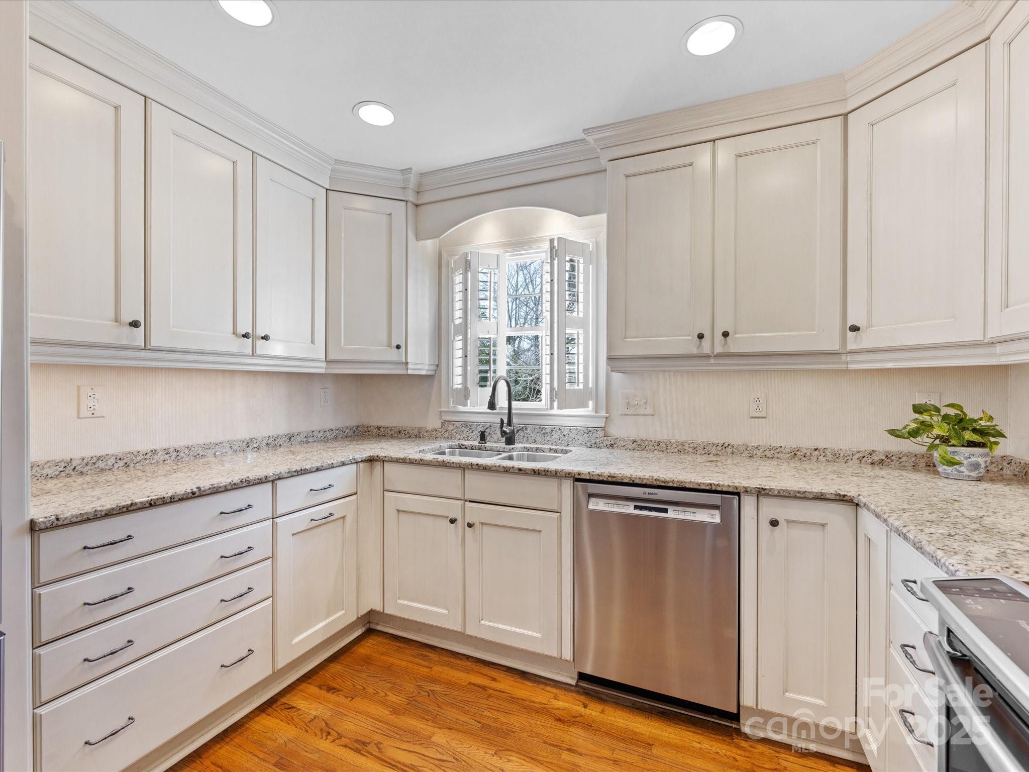 555 Manning Drive, Unit 7 Charlotte, NC 28209 - Photo 12 of 45 a kitchen with granite countertop white cabinets and white appliances