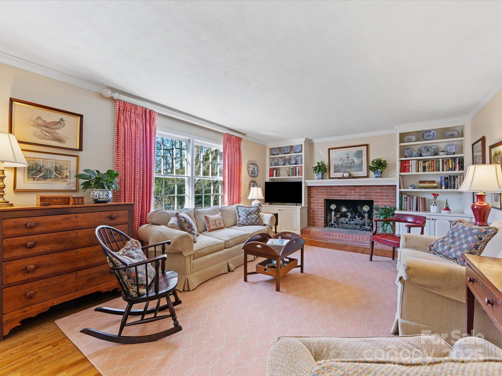 555 Manning Drive, Unit 7 Charlotte, NC 28209 - Photo 16 of 45 a living room with furniture large window and a fireplace