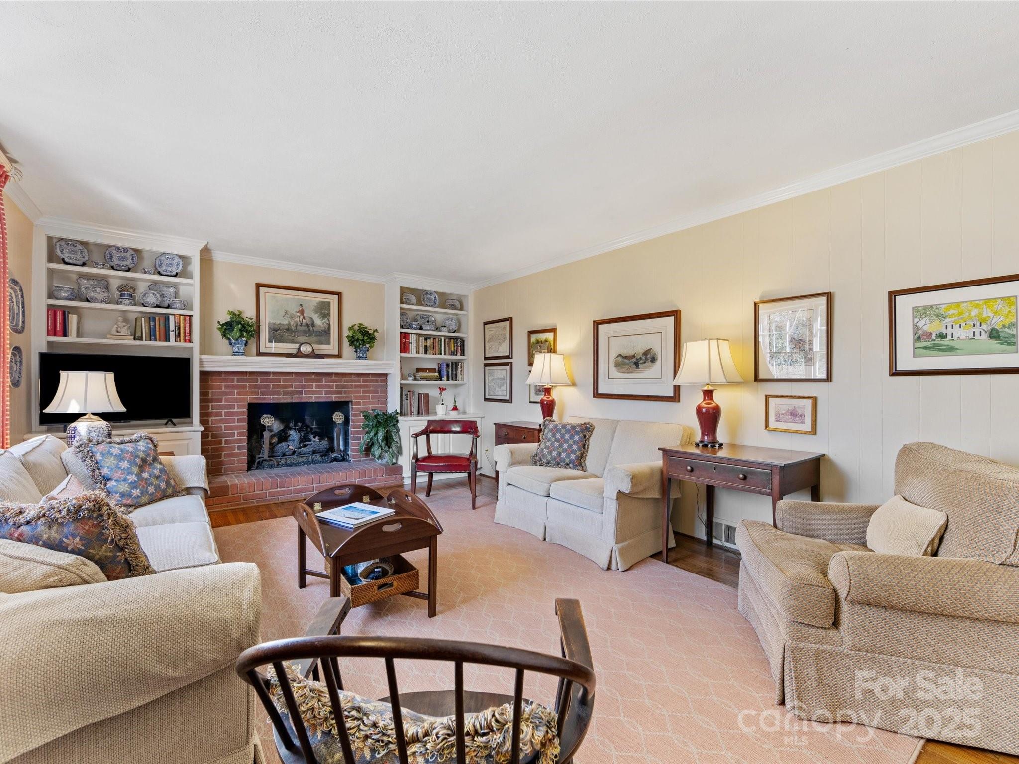 555 Manning Drive, Unit 7 Charlotte, NC 28209 - Photo 17 of 45 a living room with furniture a flat screen tv and a fireplace
