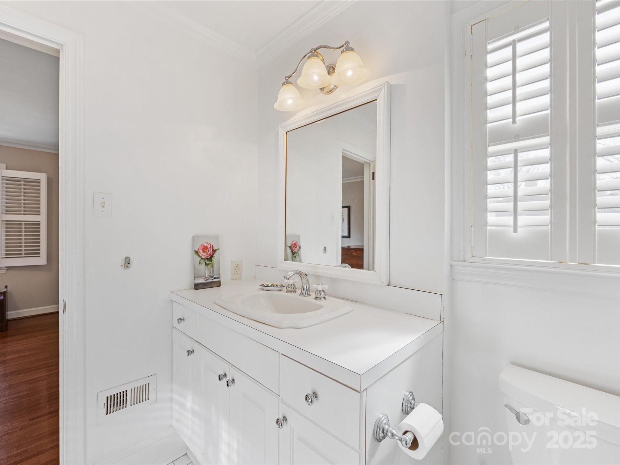 555 Manning Drive, Unit 7 Charlotte, NC 28209 - Photo 24 of 45 a bathroom with a sink vanity and a mirror