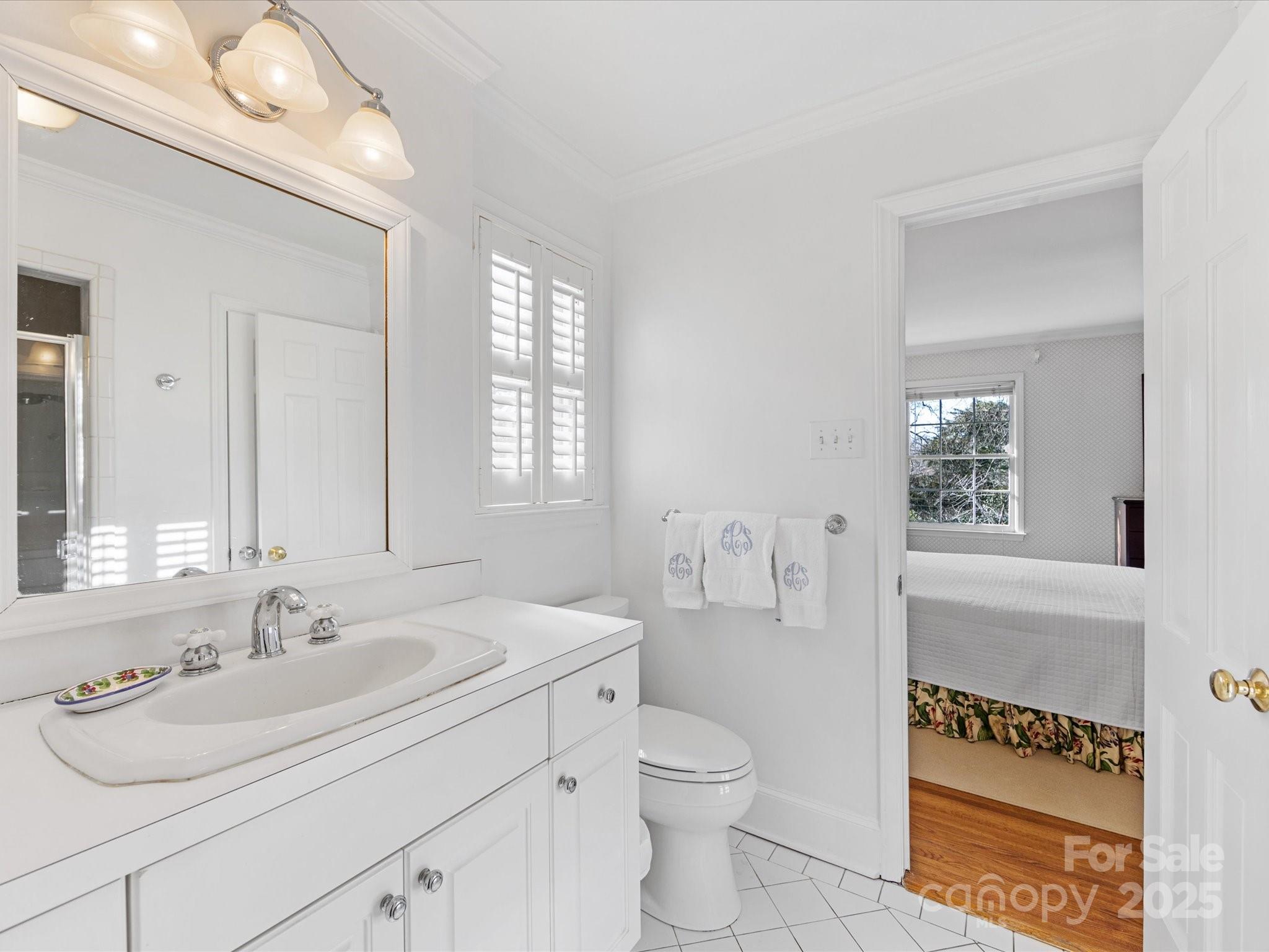 555 Manning Drive, Unit 7 Charlotte, NC 28209 - Photo 25 of 45 a bathroom with a sink a toilet and a mirror