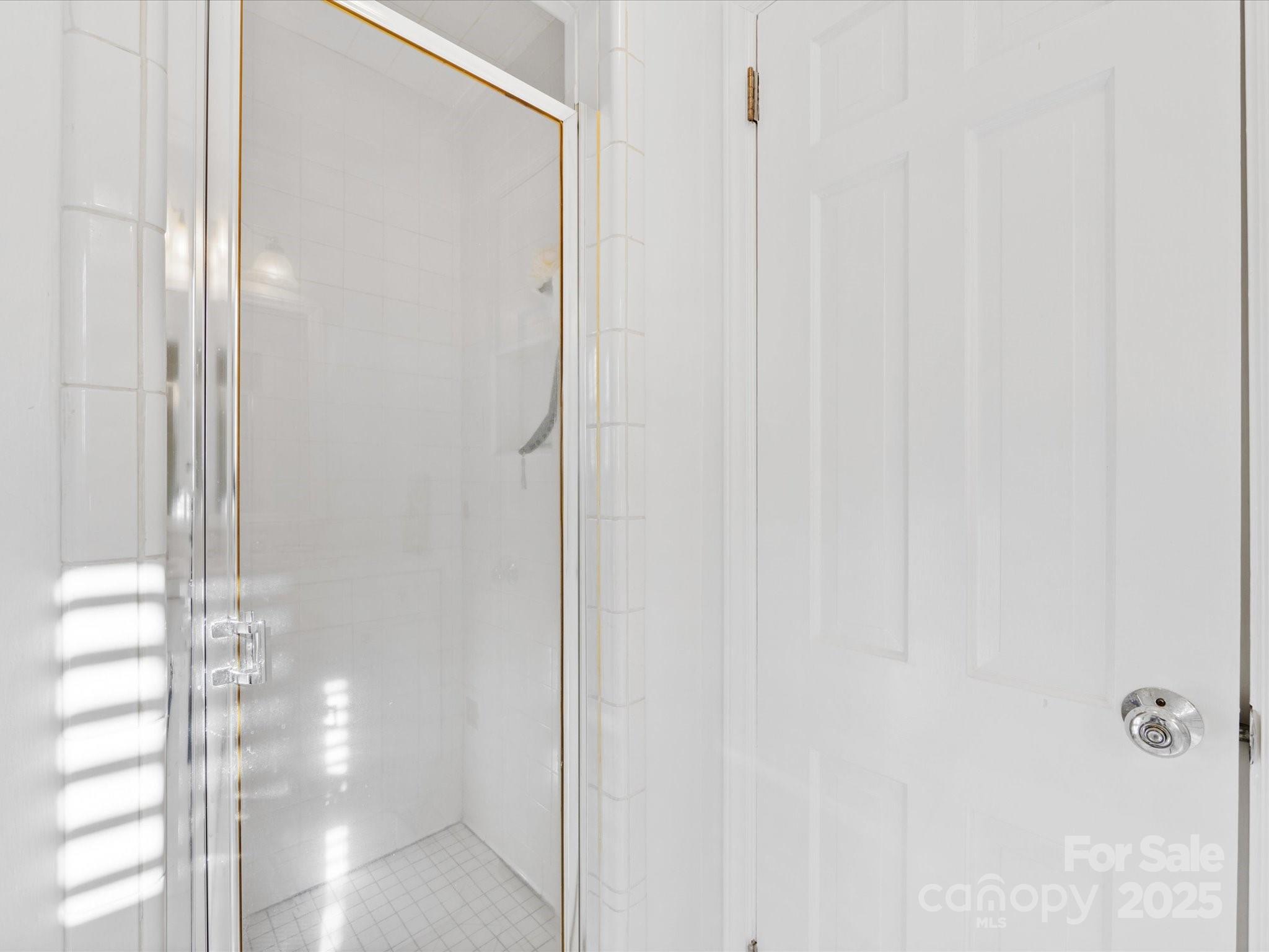 555 Manning Drive, Unit 7 Charlotte, NC 28209 - Photo 26 of 45 a bathroom with a glass shower door