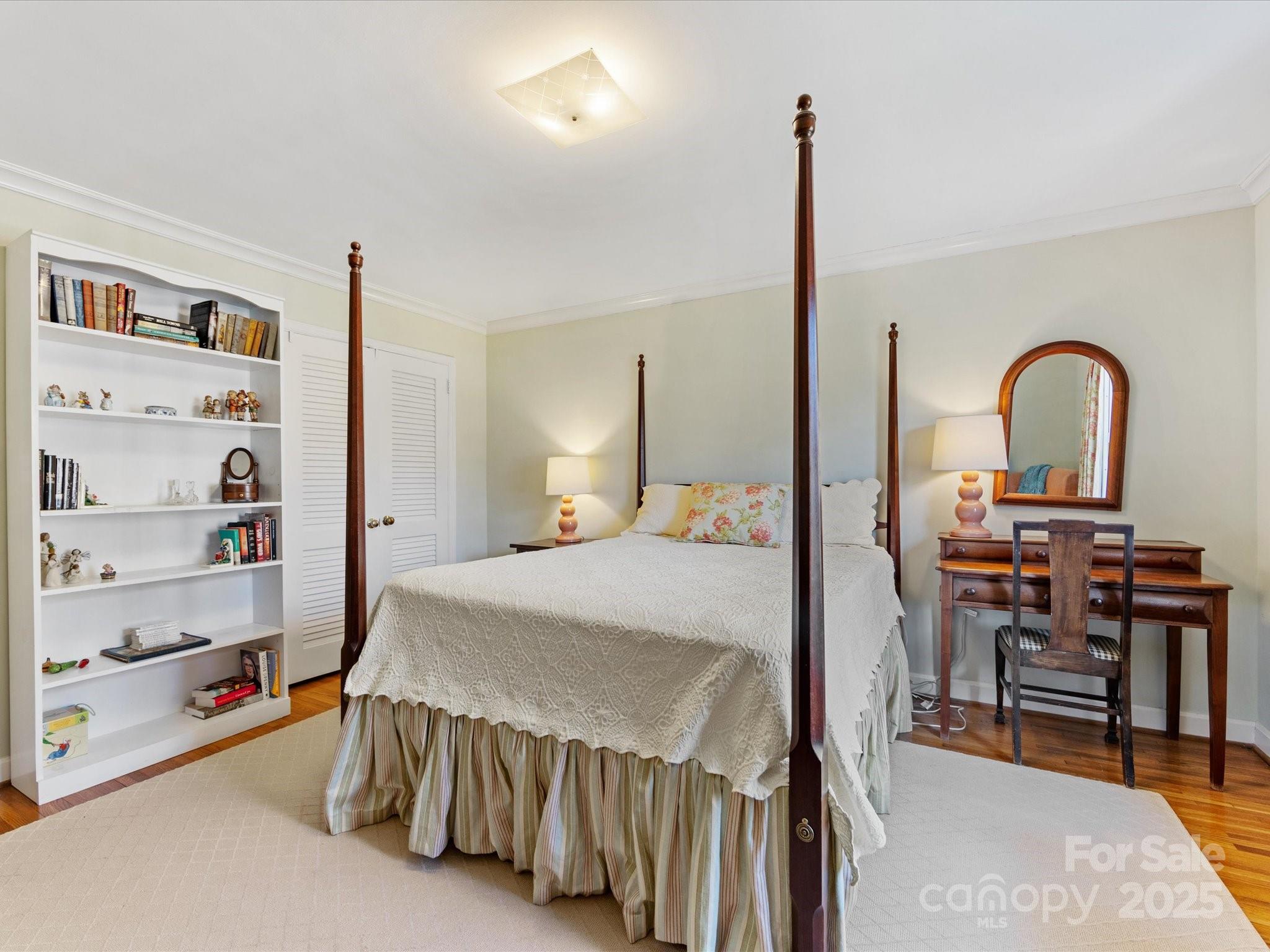 555 Manning Drive, Unit 7 Charlotte, NC 28209 - Photo 30 of 45 a bedroom with a bed a table and bookshelf