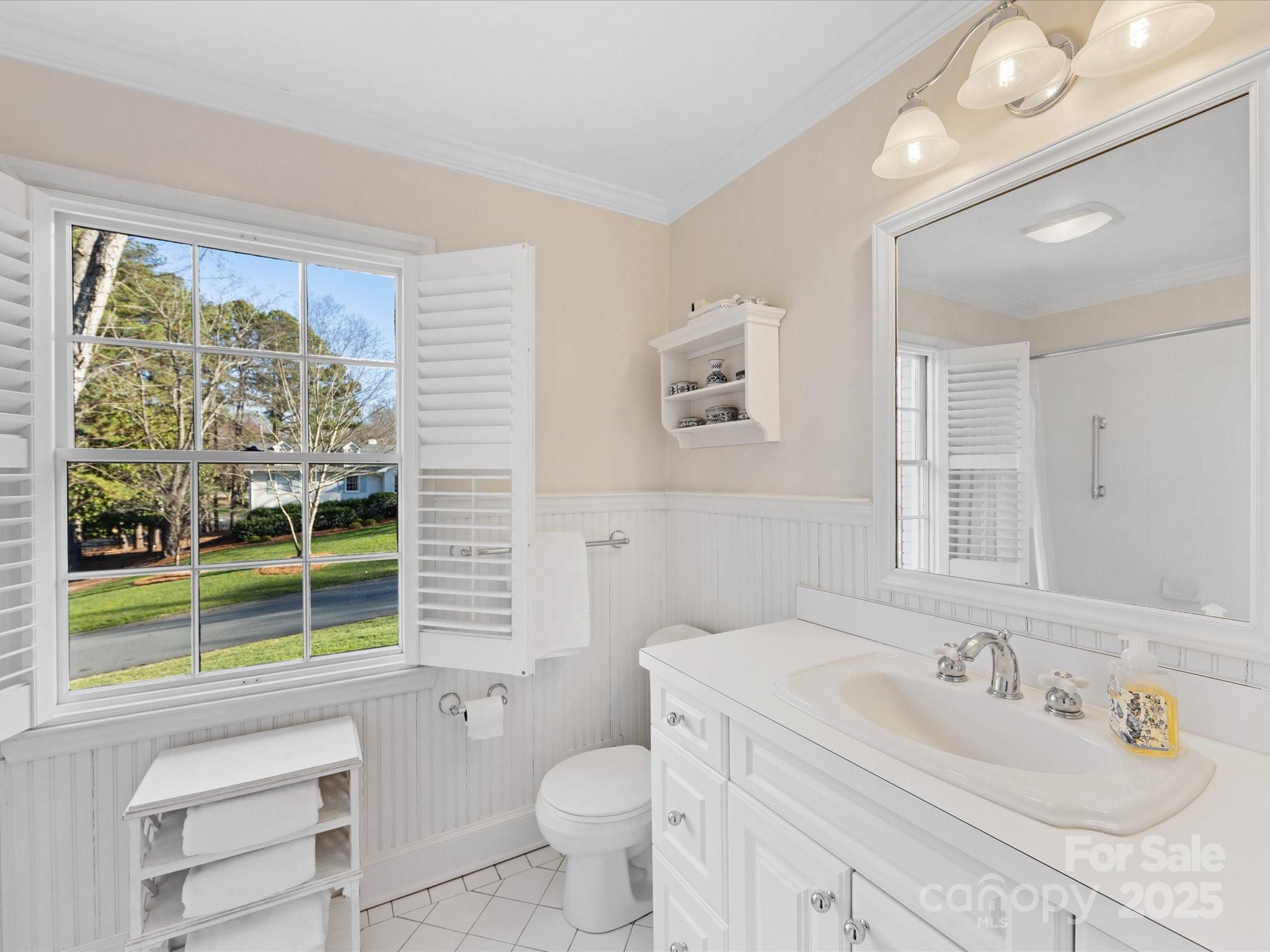 555 Manning Drive, Unit 7 Charlotte, NC 28209 - Photo 31 of 45 a bathroom with a sink a toilet a large mirror and a window