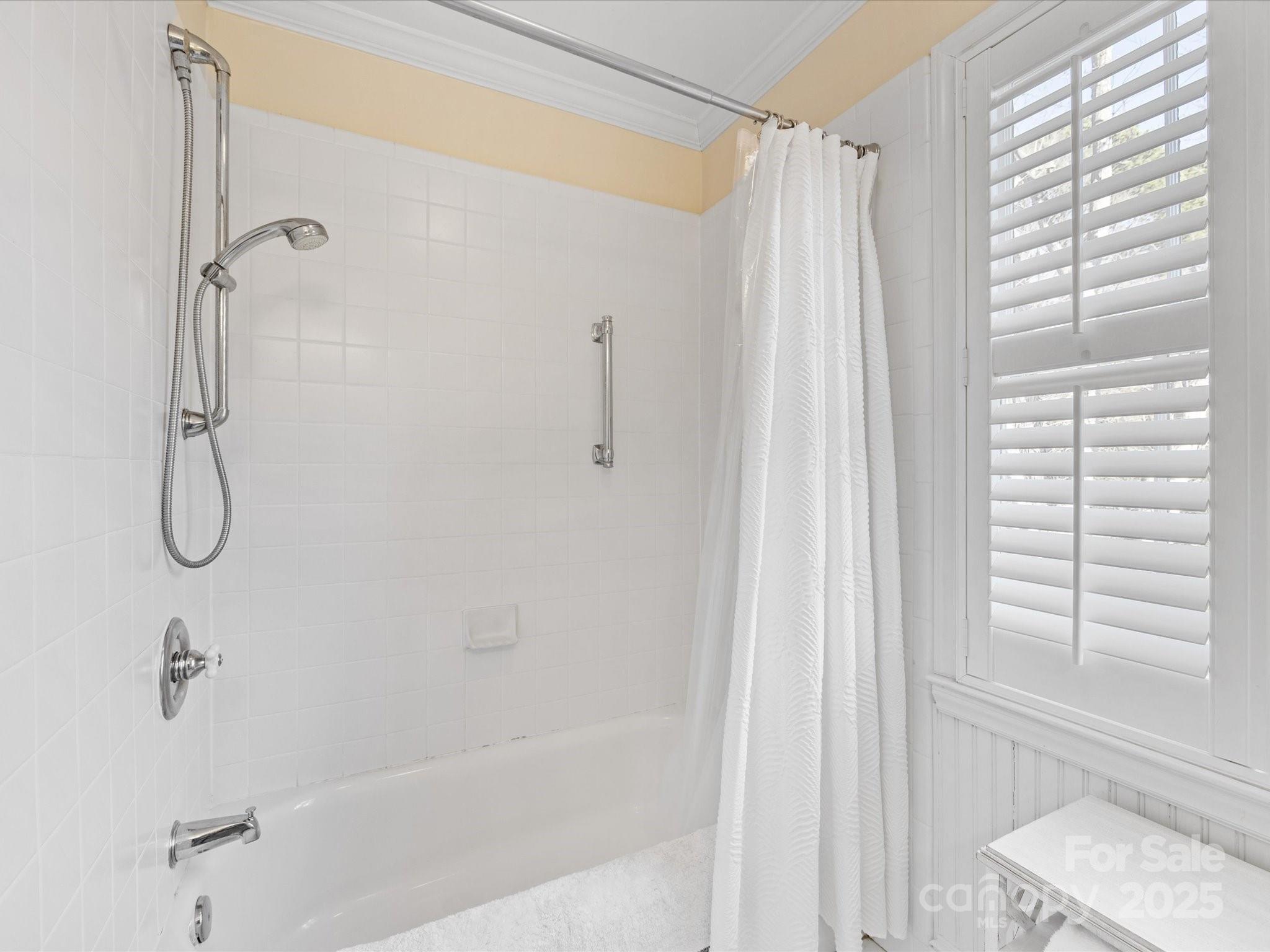 555 Manning Drive, Unit 7 Charlotte, NC 28209 - Photo 32 of 45 a bathroom with a shower and a window