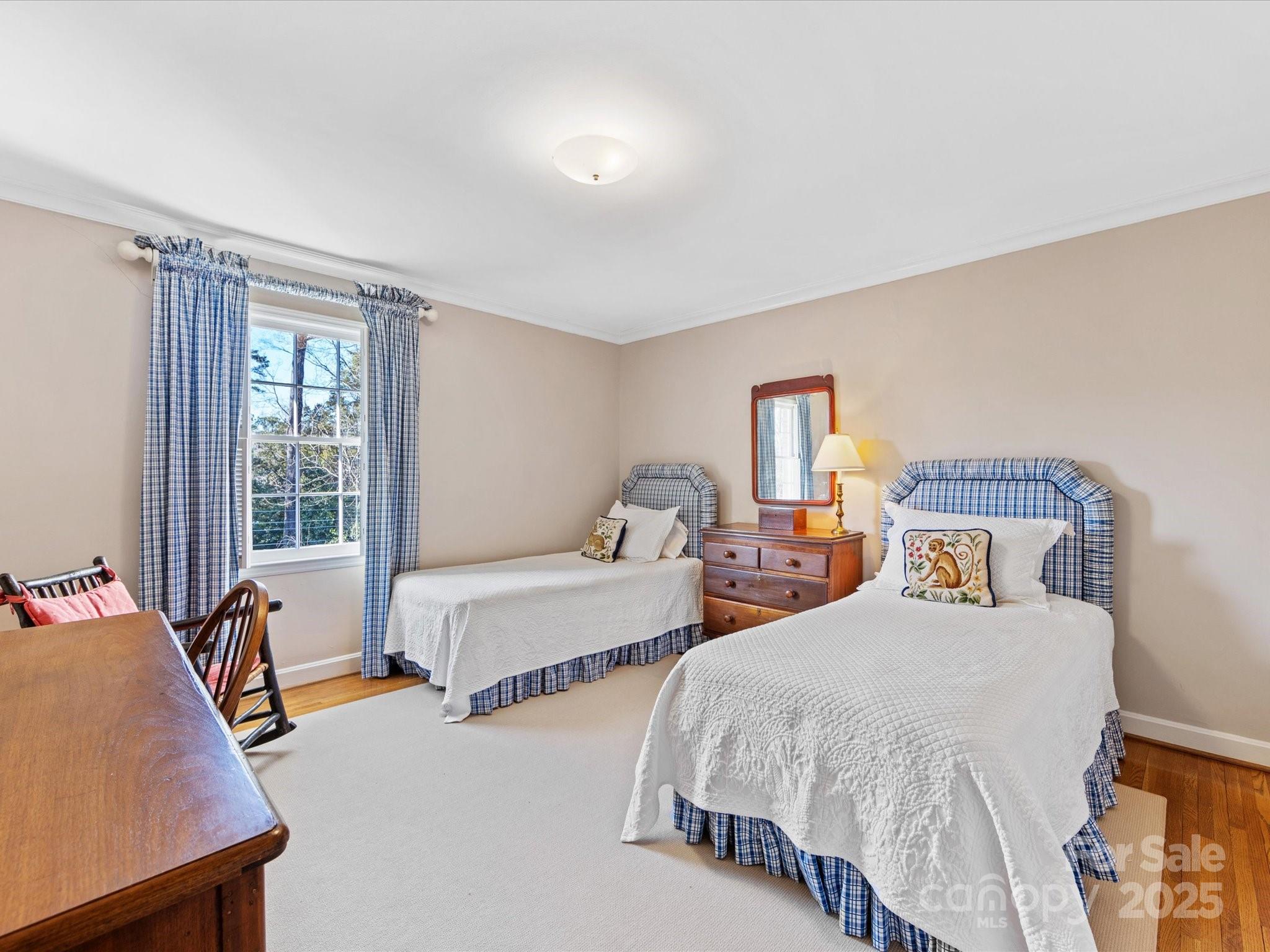 555 Manning Drive, Unit 7 Charlotte, NC 28209 - Photo 33 of 45 a bedroom with two beds and a table