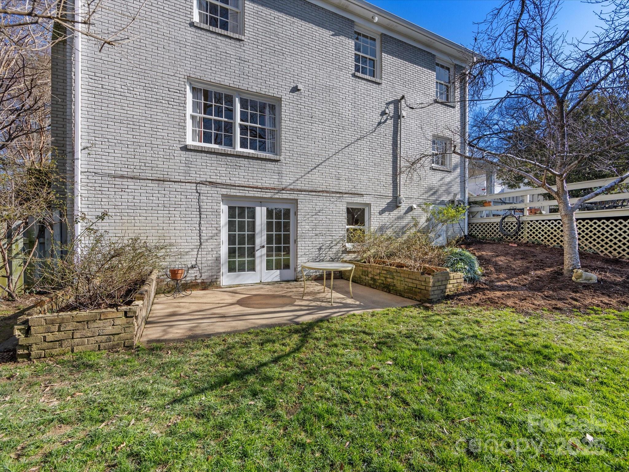 555 Manning Drive, Unit 7 Charlotte, NC 28209 - Photo 43 of 45 a view of a house with a yard and sitting area