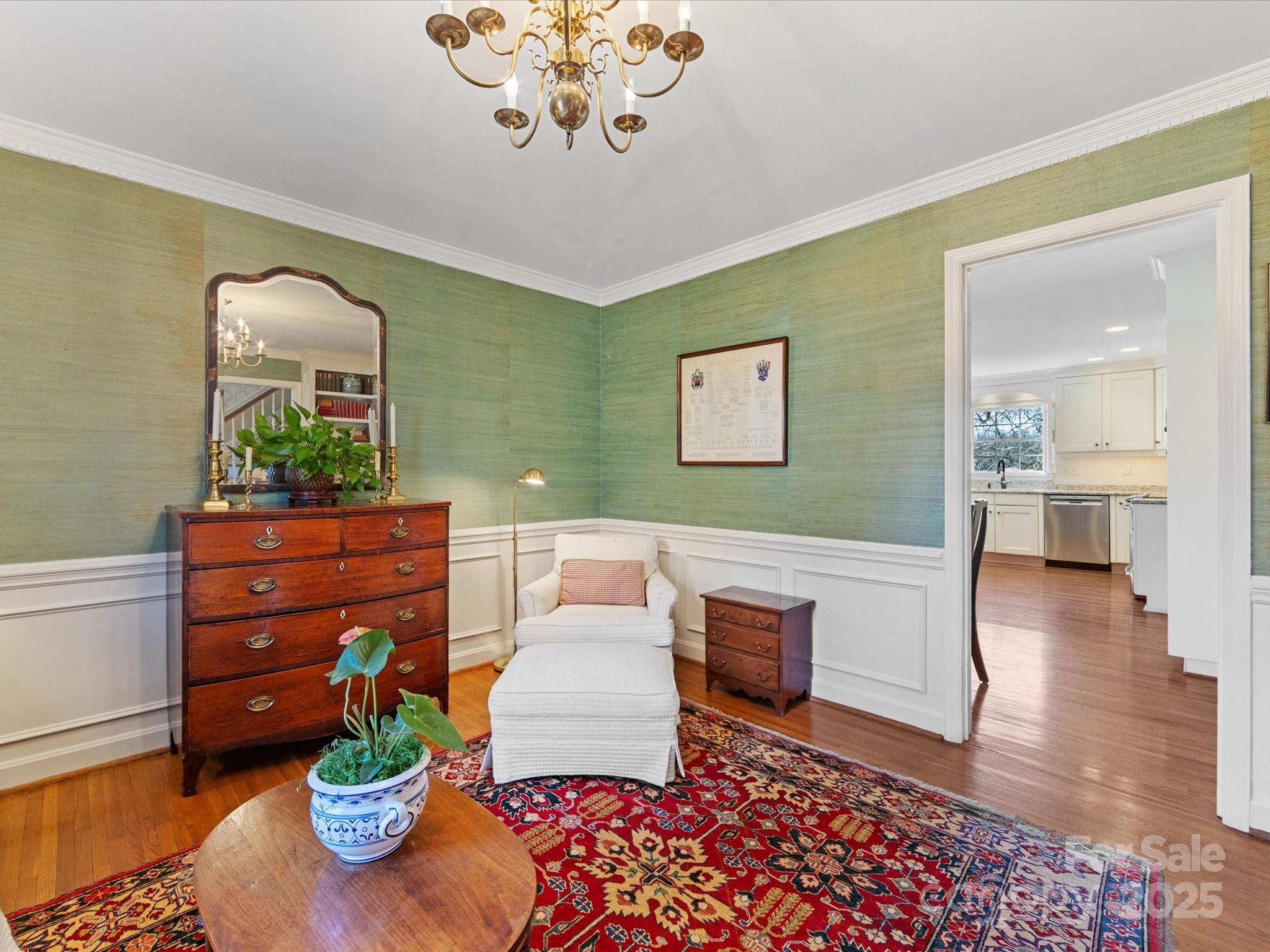 555 Manning Drive, Unit 7 Charlotte, NC 28209 - Photo 9 of 45 a living room with furniture and a chandelier