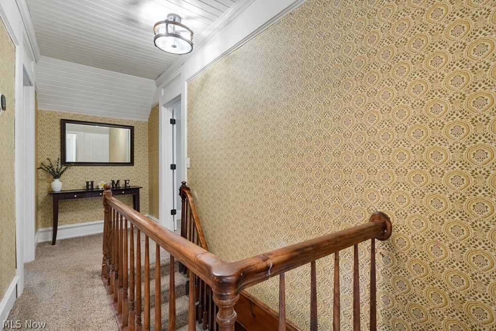 23055 Snell Road Columbia Station, OH 44028 - Photo 31 of 50 Hallway featuring patterned wallpaper and wood-finish railing