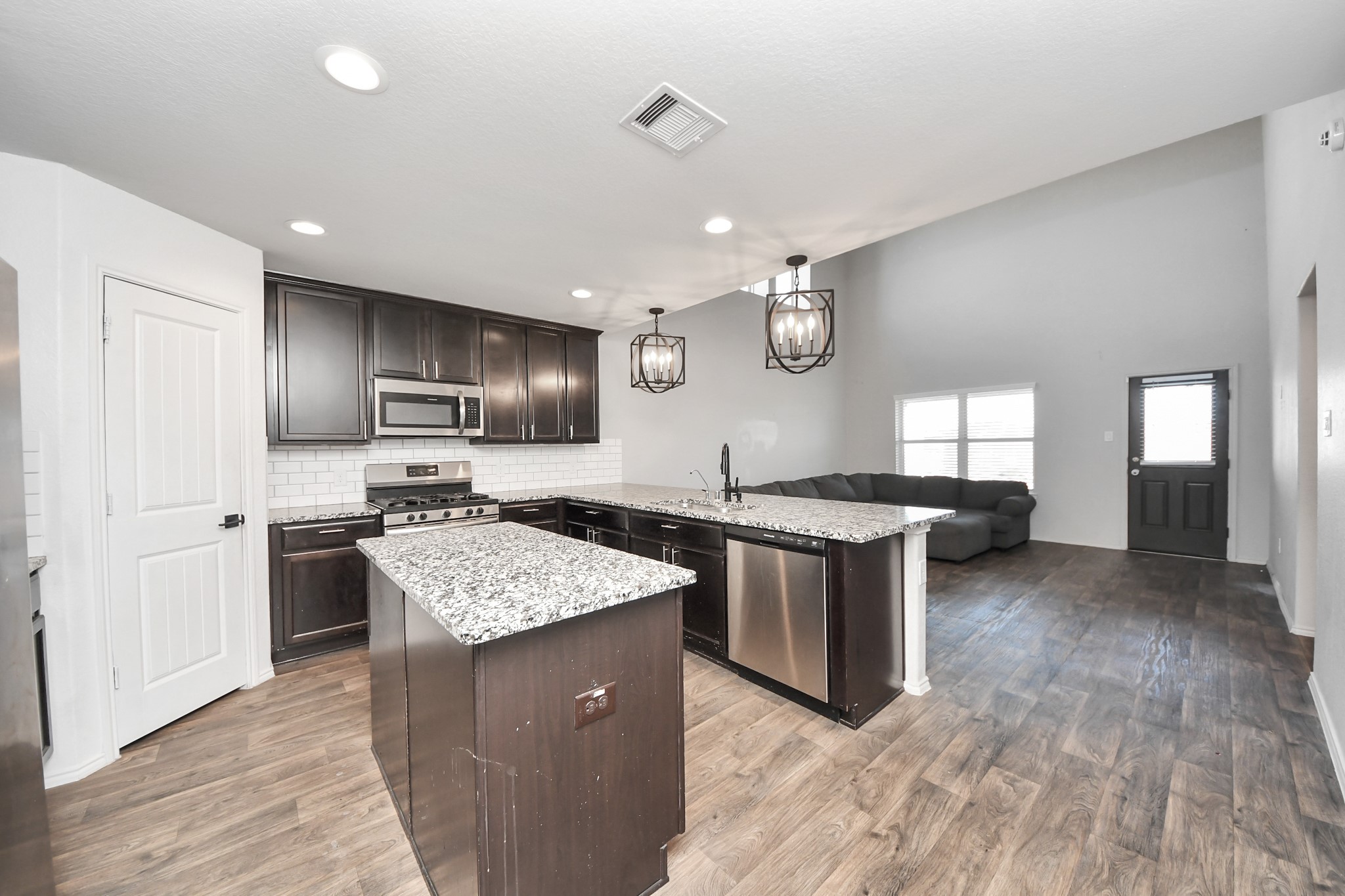 619 Ashley Falls Lane Rosharon, TX 77583 - Photo 10 of 31 The heart of the home is the expansive open-concept living area that flows seamlessly into the kitchen, creating an ideal environment for entertaining and everyday comfort.