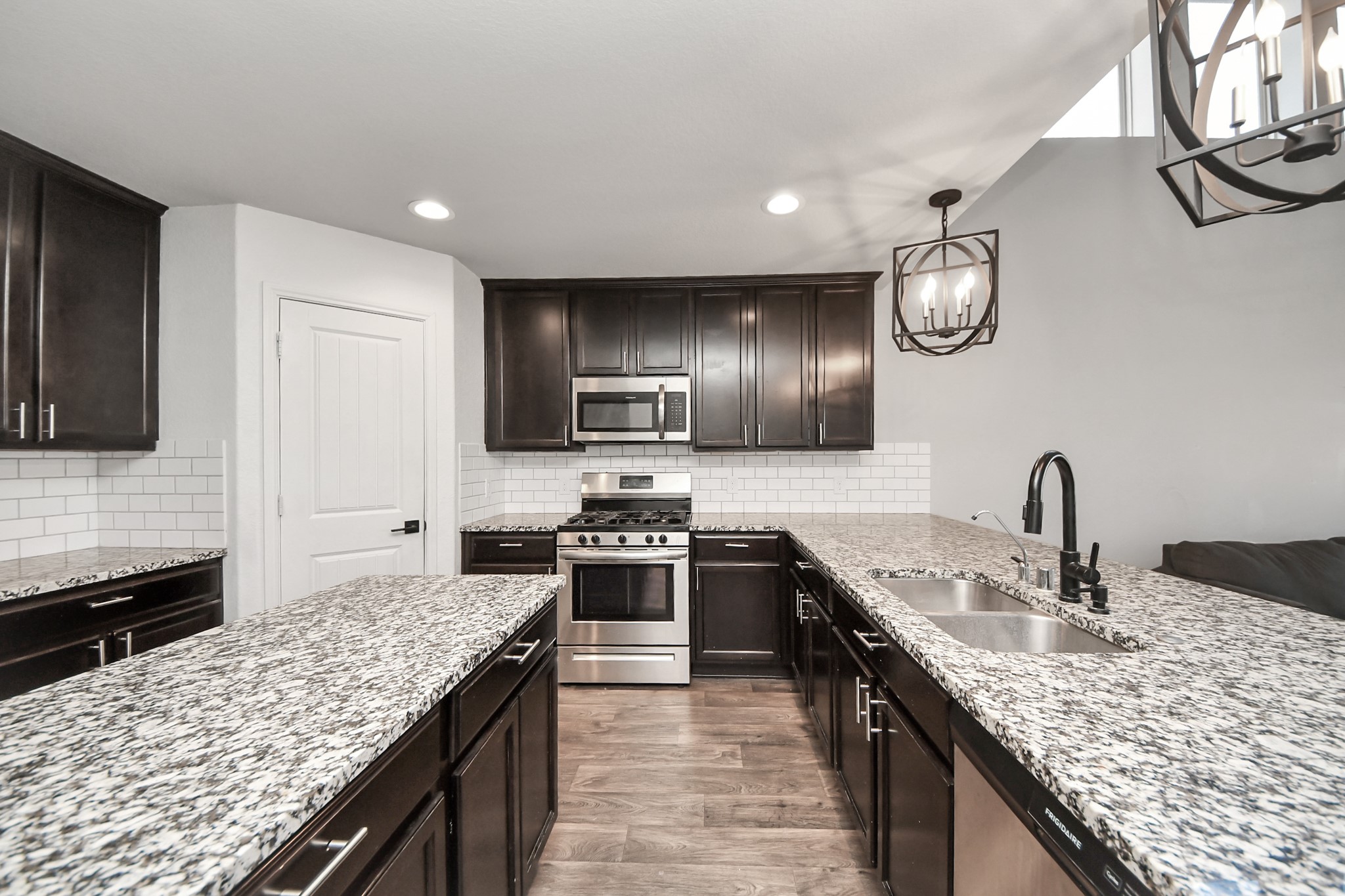 619 Ashley Falls Lane Rosharon, TX 77583 - Photo 11 of 31 The kitchen is truly a showstopper, featuring granite countertops, a massive center island, and an abundance of cabinet and counter space