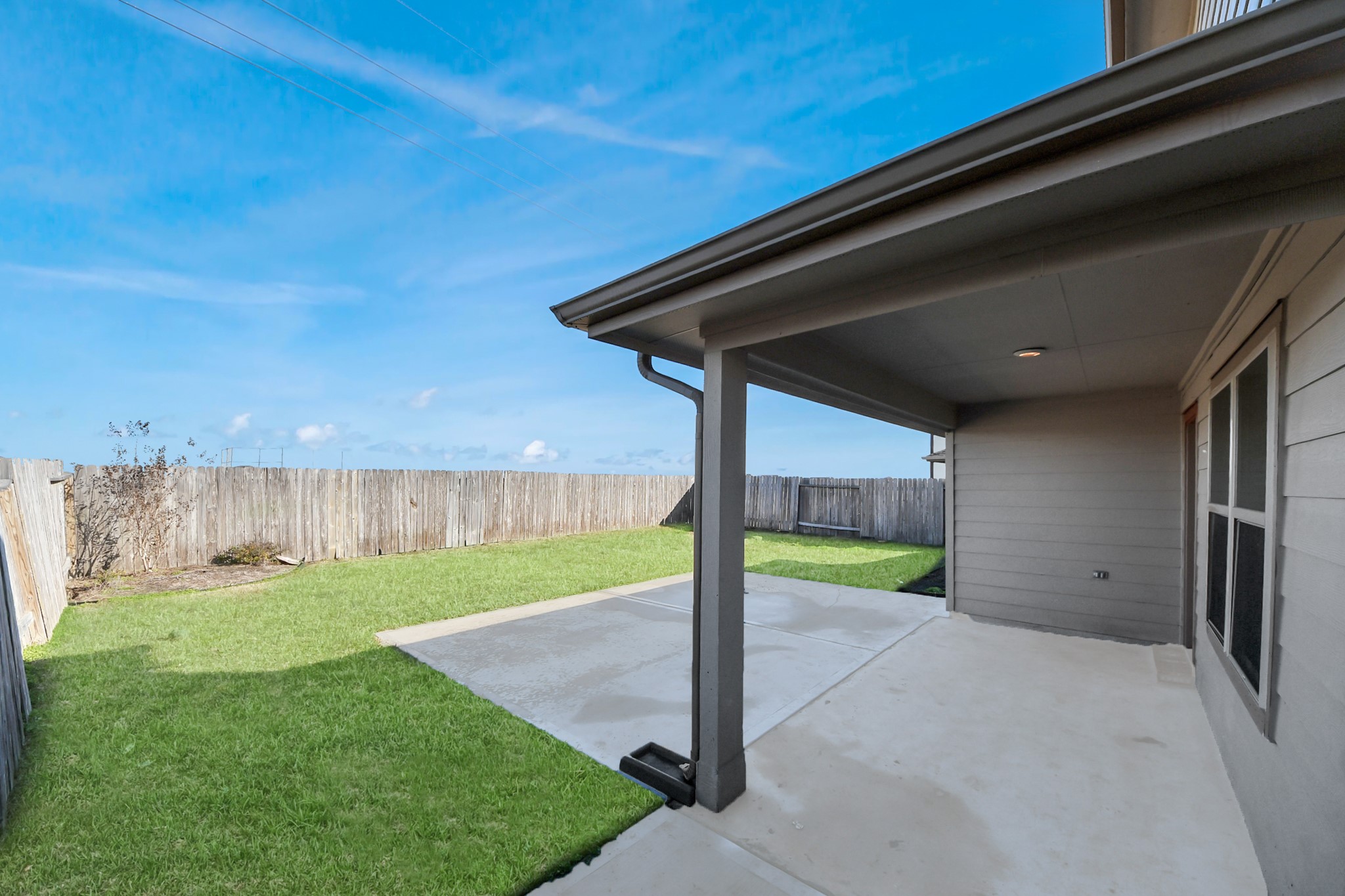 619 Ashley Falls Lane Rosharon, TX 77583 - Photo 26 of 31 Step out back to a covered patio overlooking the fenced backyard with no back neighbors, offering extra privacy and a peaceful place to unwind or host gatherings.