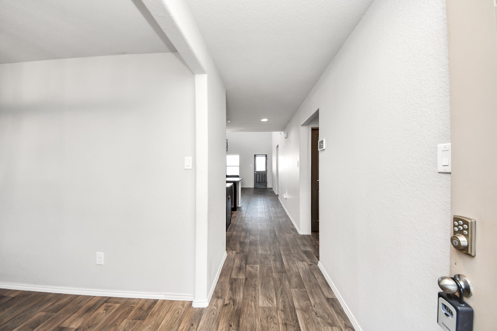 619 Ashley Falls Lane Rosharon, TX 77583 - Photo 5 of 31 Gorgeous flooring throughout the downstairs adds warmth and elegance, while large windows allow natural light to fill the home.
