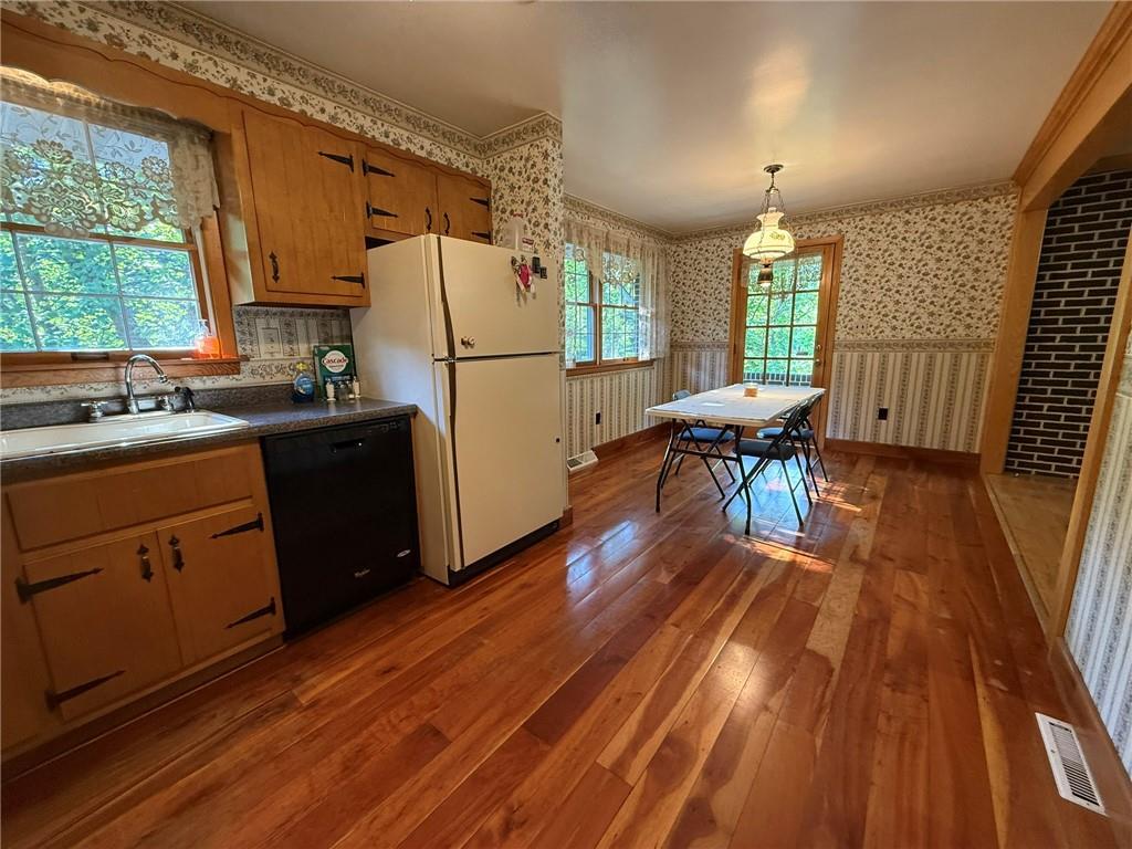 960 Watt Road Apollo, PA 15613 - Photo 11 of 24 a kitchen with granite countertop wooden floors sink and white appliances