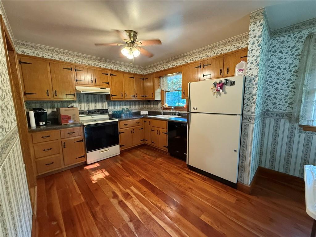 960 Watt Road Apollo, PA 15613 - Photo 10 of 24 a kitchen with stainless steel appliances granite countertop a refrigerator a stove a sink dishwasher and white countertops with wooden floor