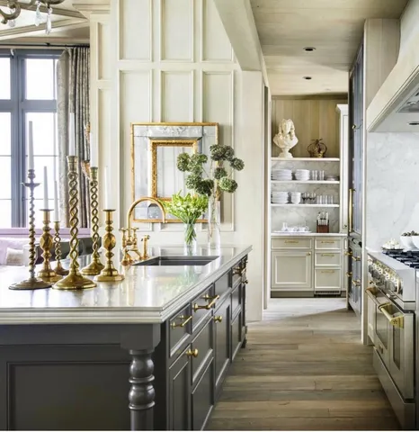a kitchen with kitchen island a sink stove and white cabinets