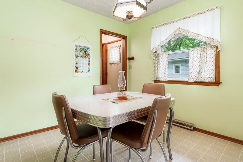 4702 Mohawk Road Rockford, IL 61107 - Photo 11 of 41 a view of a dining room with furniture and a chandelier