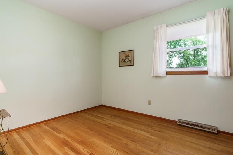 4702 Mohawk Road Rockford, IL 61107 - Photo 16 of 41 an empty room with wooden floor and windows