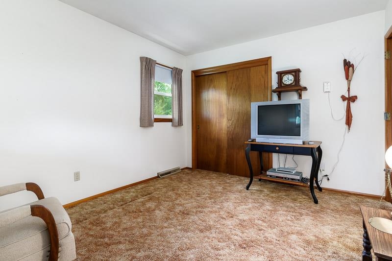 4702 Mohawk Road Rockford, IL 61107 - Photo 22 of 41 a bedroom with a bed and a flat screen tv
