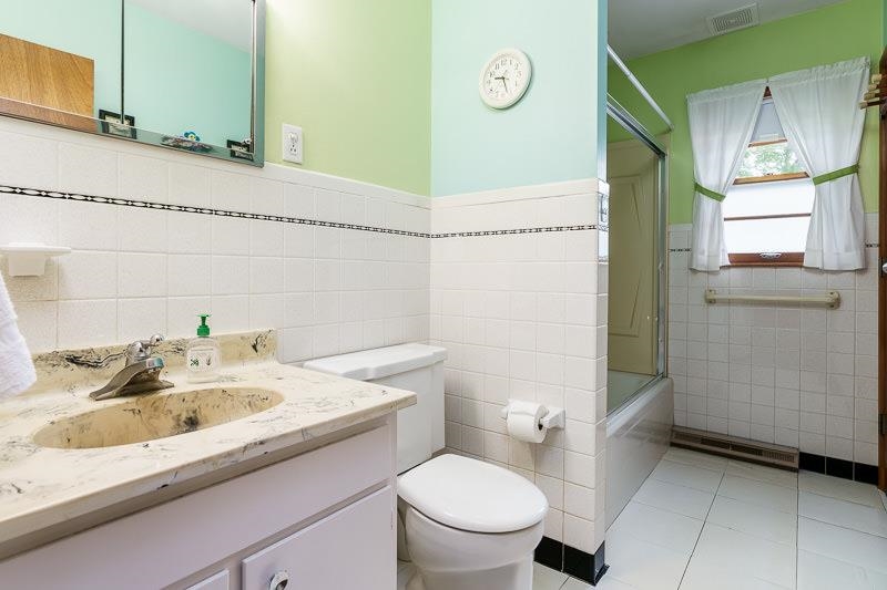 4702 Mohawk Road Rockford, IL 61107 - Photo 23 of 41 a bathroom with a sink a toilet and a mirror