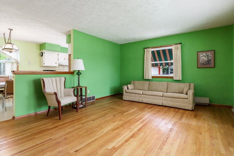 4702 Mohawk Road Rockford, IL 61107 - Photo 7 of 41 a living room with furniture and a wooden floor