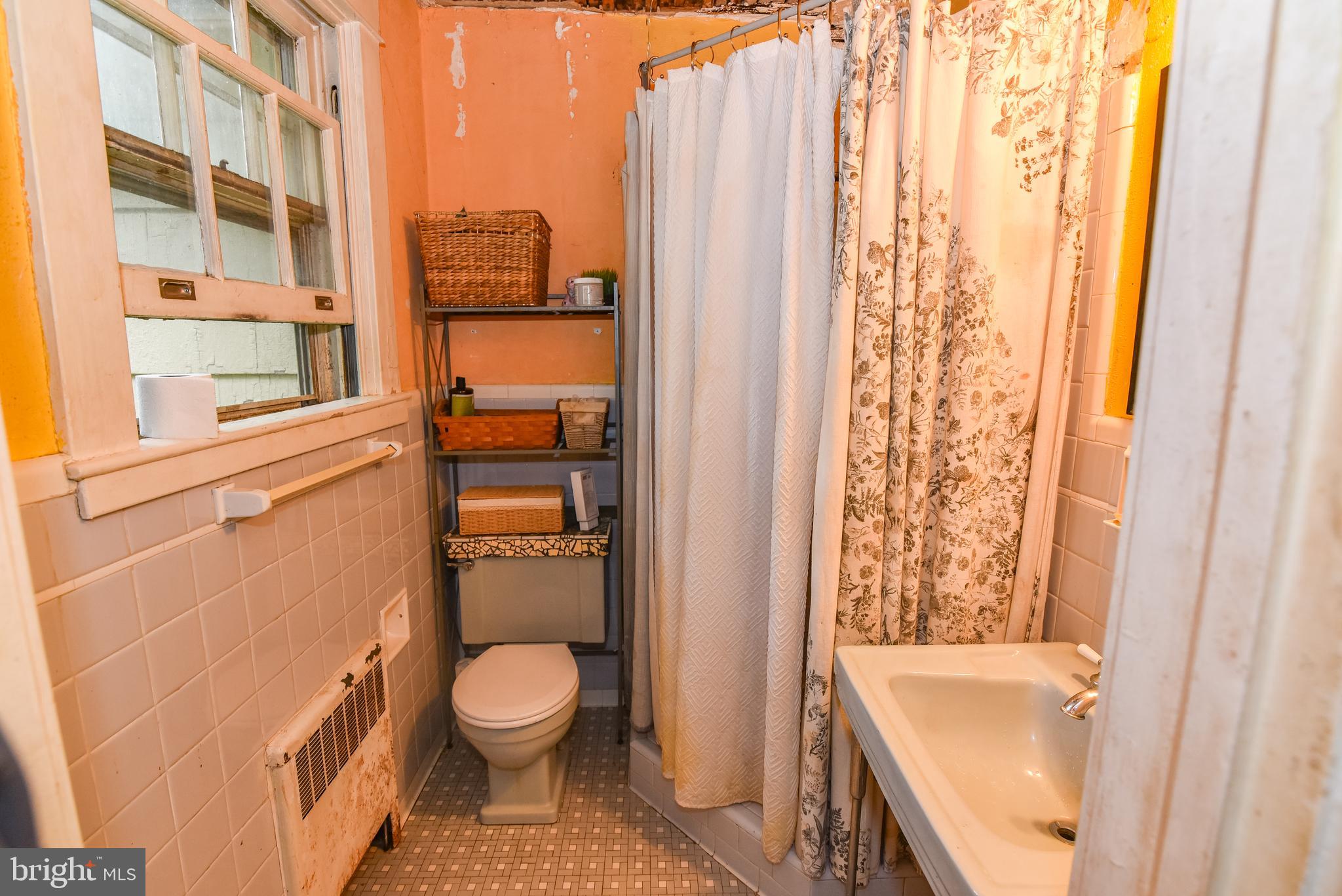 24 Merrymount Road Baltimore, MD 21210 - Photo 29 of 48 a bathroom with a toilet and a shower curtain