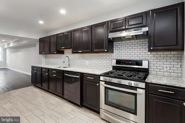 a kitchen with stainless steel appliances wooden cabinets and stove