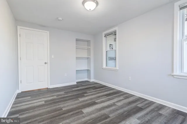a view of a room with wooden floor and windows