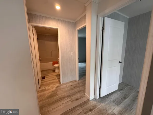 a view of a bathroom from a hallway