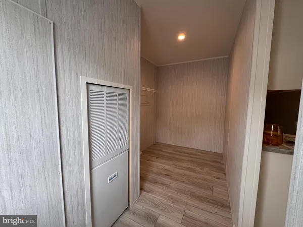 a view of hallway with wooden floor