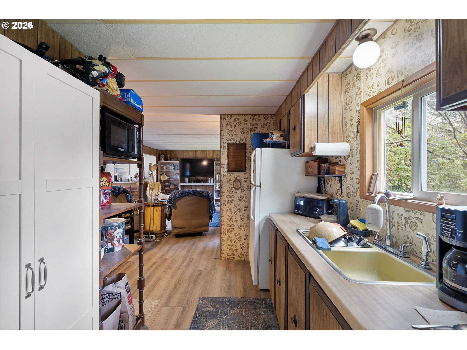 4826 Rhododendron Loop Florence, OR 97439 - Photo 11 of 41 a kitchen that has a lot of cabinets a sink and a stove