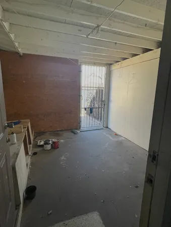 a room with water heater and a wooden door