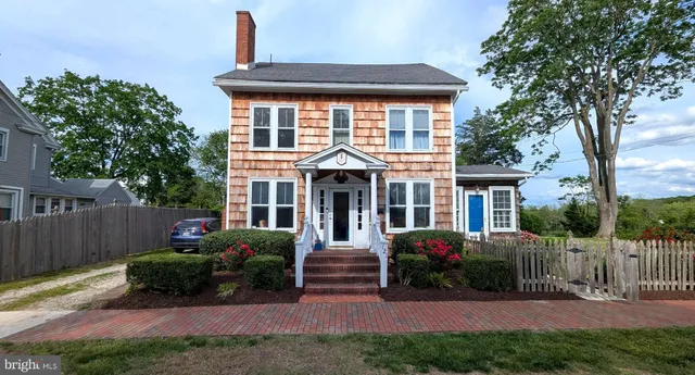 a living room with furniture a fireplace and a large window