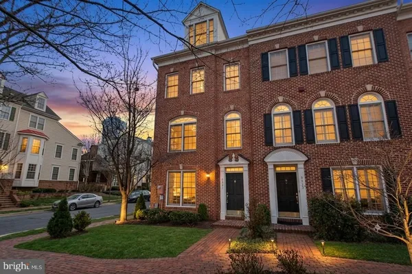 a front view of a brick house with a yard