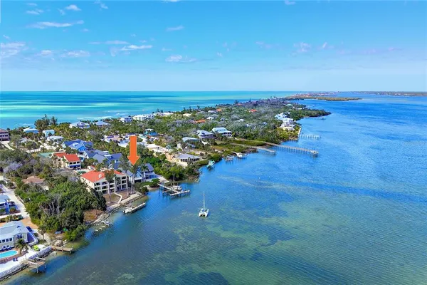 an aerial view of a houses with an ocean view
