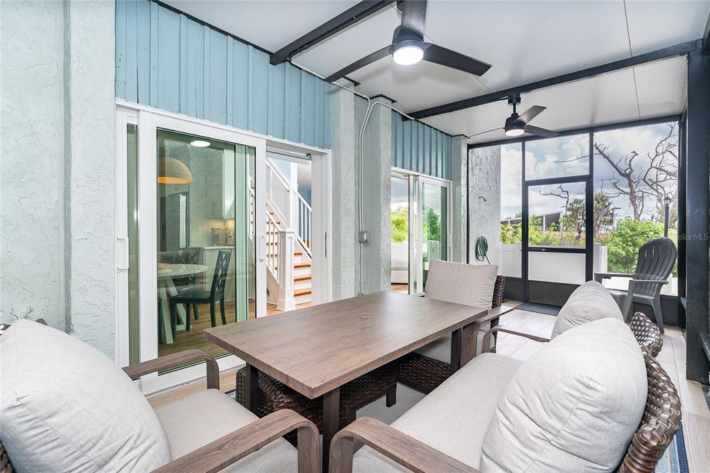 6005 North Beach Road, Unit 16 Englewood, FL 34223 - Photo 17 of 57 a living room with furniture a large window and a table