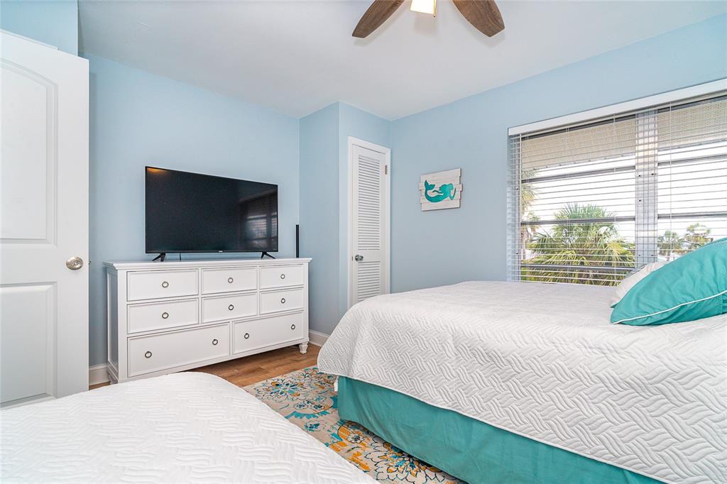 6005 North Beach Road, Unit 16 Englewood, FL 34223 - Photo 27 of 57 a bedroom with a bed and a flat screen tv