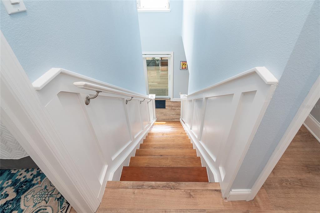 6005 North Beach Road, Unit 16 Englewood, FL 34223 - Photo 29 of 57 a view of a hallway with wooden floor and staircase