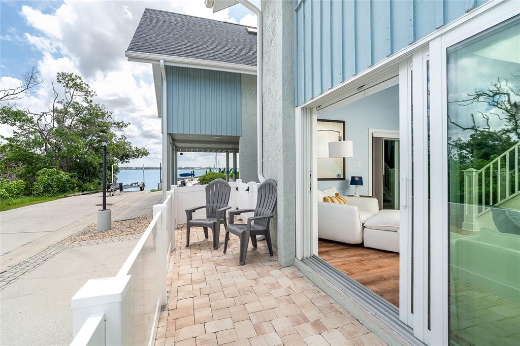 6005 North Beach Road, Unit 16 Englewood, FL 34223 - Photo 33 of 57 a dining room with furniture and a garden